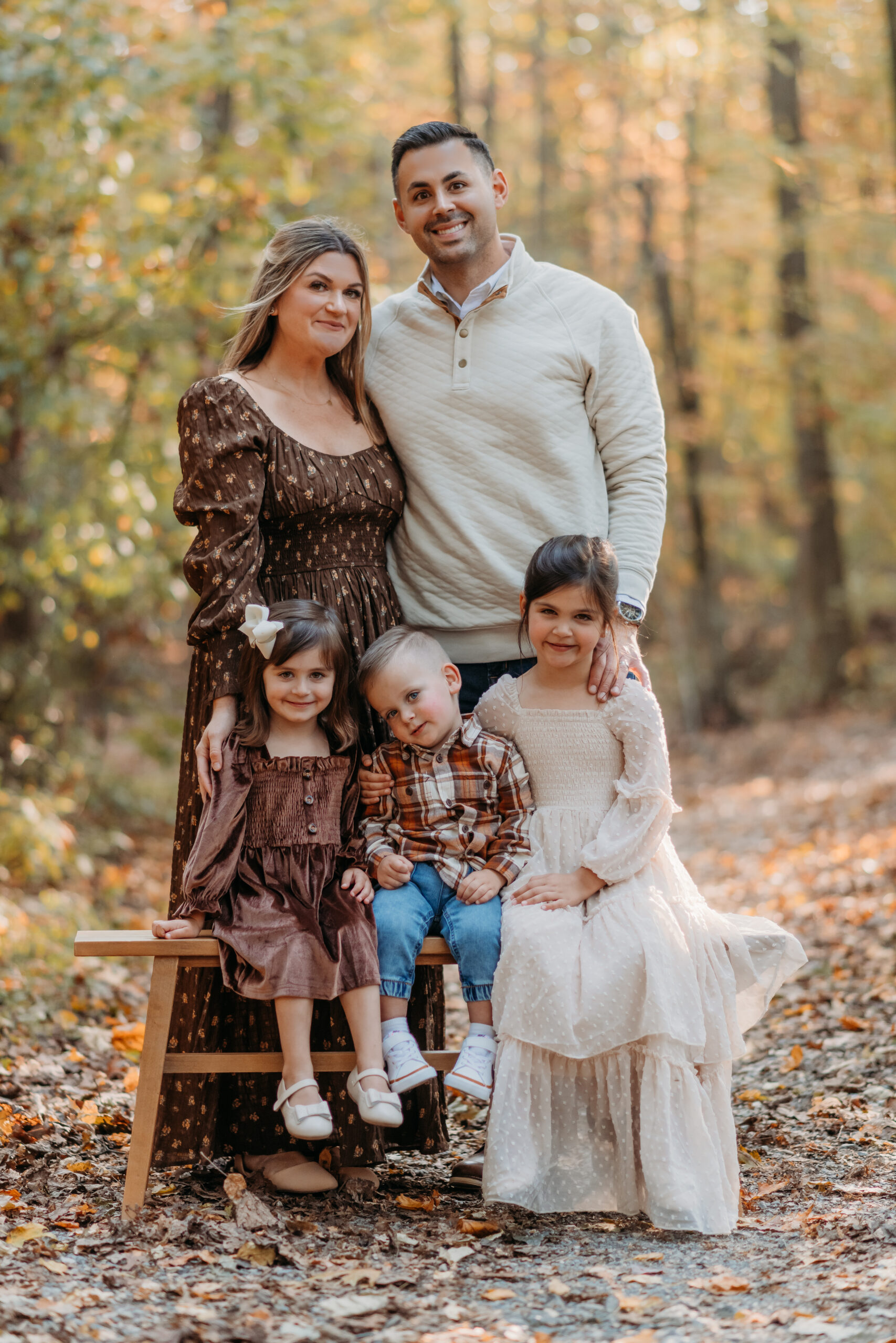 family portrait in a trail of fall foliage