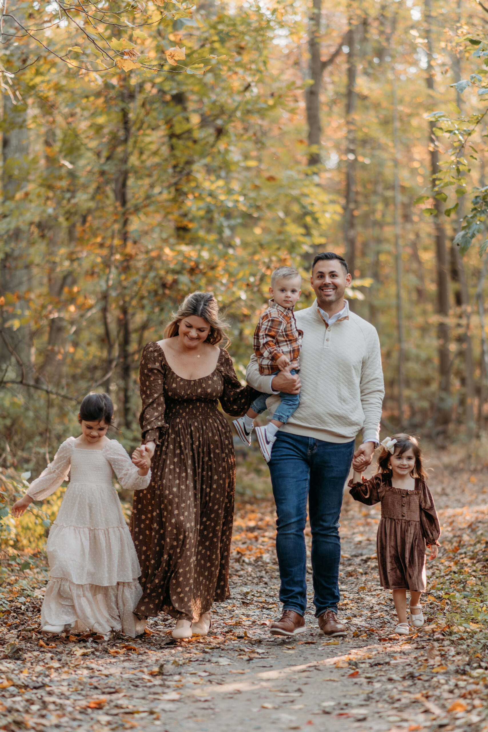Photo of family walking on a trail in the fall