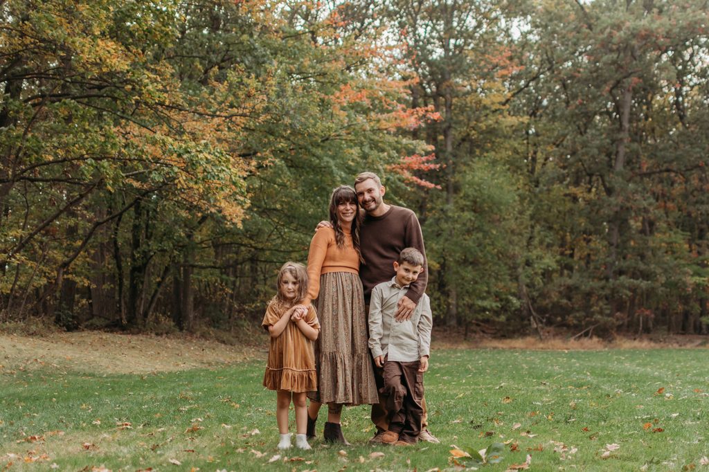 Family coordinating in warm fall tones for their York, Pennsylvania family photo session