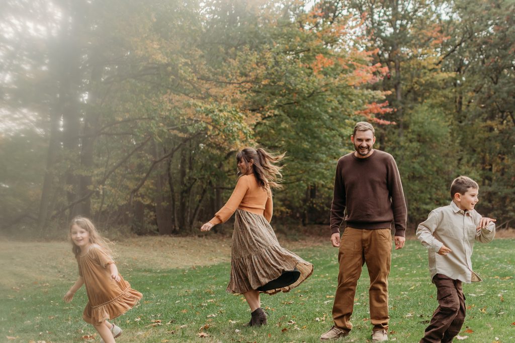 Family dancing and laughing during fall photo session in york, pa