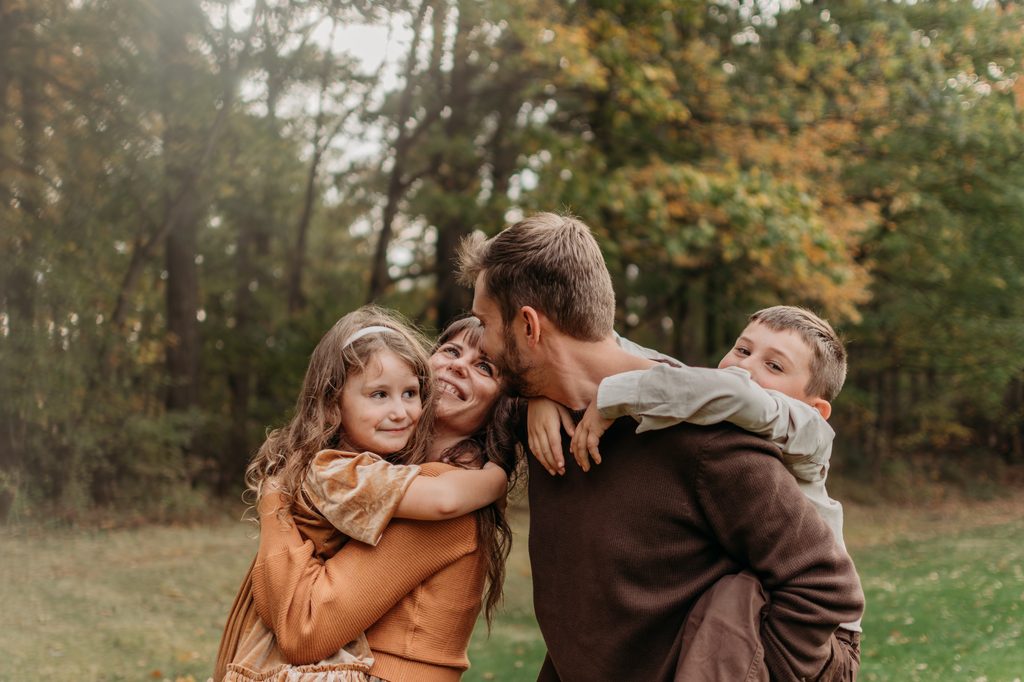 close-up of family photo session with kids embracing mom and dad